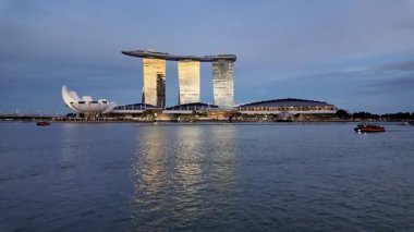 Marina Bay, Singapore - Jul 09 2024: Marina Bay Sands is reflected in the water. There are boats in the water near the building