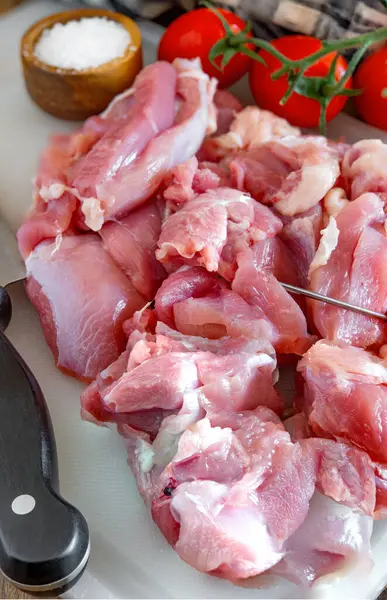 stock image raw turkey meat morsels on cutting board with sharp knife