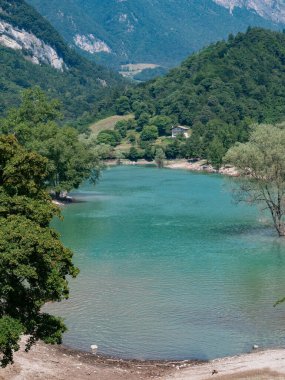 Vertical panoramic view of alpine Tenno lake, Trentino Alto Adige, during the day clipart