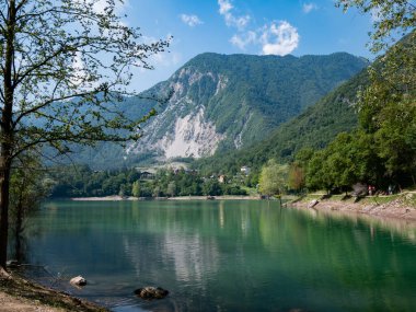 Vertical panoramic view of alpine Tenno lake, Trentino Alto Adige, during the day clipart