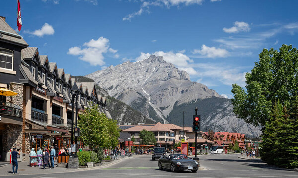 View along Banff Avenue towards snow capped Cascade Mountain in Banff, Alberta, Canada on 4 June 2023