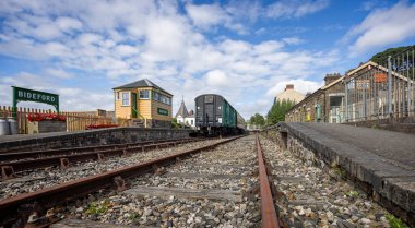 Vintage signal box and railway carriages at Bideford Heritage Railway centre, Devon, UK on 3 September 2024 clipart