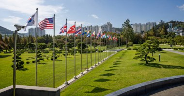 Row of Country flag poles at the UN Memorial Cemetery in  Busan, Korea on 1 Ocotber 2024