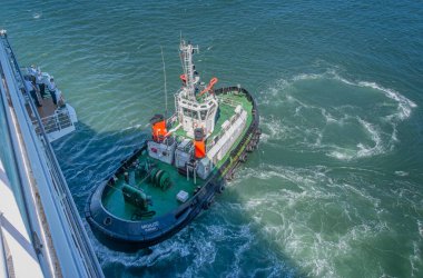 Tug Mkhuze helping cruise ship Azamara Quest dock at Durban in windy conditions, South Africa, on 15 December 2024 clipart