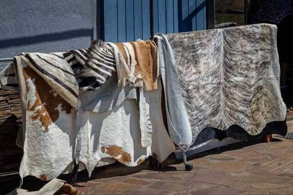 Collection of african animal hides including zebra and antelope on sale at Tala Game Reserve, near Durban, South Africa on 15 December 2024