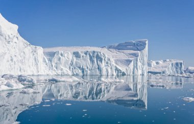 Towering great icebergs in the Ilulissat Icefjord in Greenland
