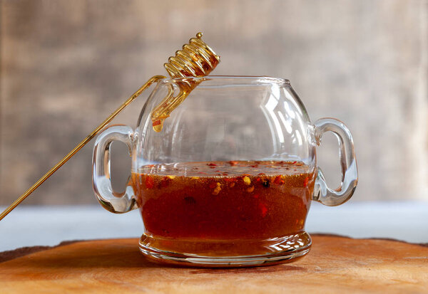 Spicy or hot chilli honey in the glass jar