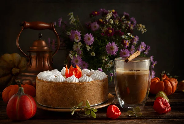 Pumpkin cheesecake with meringue on the cozy autumn background.