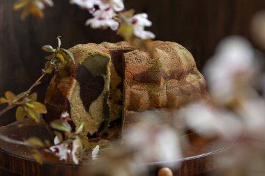 Homemade tricolor bundt Marble cake sprinkled with matcha powder clipart