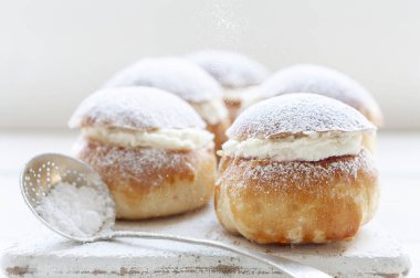 Homemade Semla or semlor, vastlakukkel, laskiaispulla - traditional Scandinavian sweet bun especially Fastelavn Shrove Monday and Shrove Tuesday	 clipart