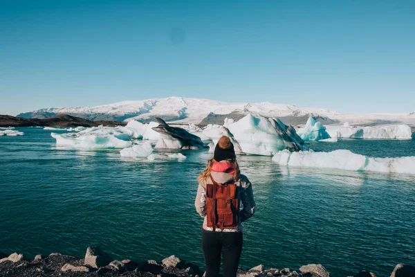 Woamn Traveller at lake Jokulsarlon, Iceland. 