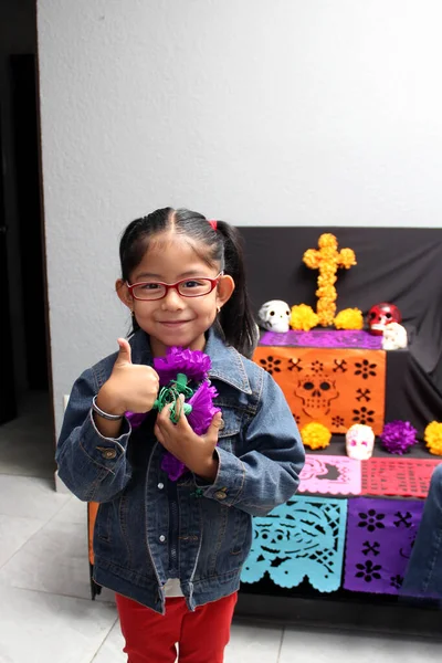 stock image Mexican child girl put the altar and offering of the Day of the Dead in their house for their deceased relatives part of the tradition and culture of Mexico