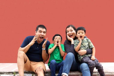 Latin, Hispanic family of mom, dad and children are sitting in the park they look happy enjoying quality time together in harmony