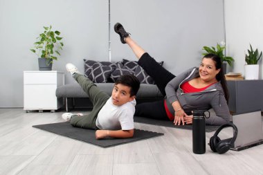Latino mom and son exercise at home to lose weight and be healthy to avoid diseases such as diabetes or hypertension