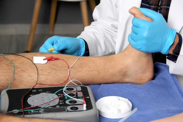 Electromyography in the lower limbs, graphic recording technique of the electrical activity produced by the tibial muscle performed by a specialist neurologist