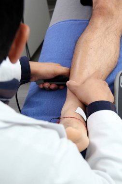 Electromyography EMG and Somatosensory Evoked Potential PEV of lower extremities, neurophysiological test applies electrical stimuli near the nerves to explore the gastroctemius muscle, calf in leg