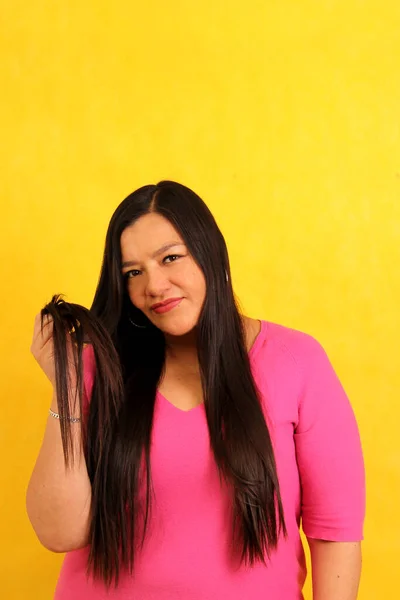 stock image Latin adult woman with very long straight hair suffers and is sad because her hair is a mess and is very damaged with split ends