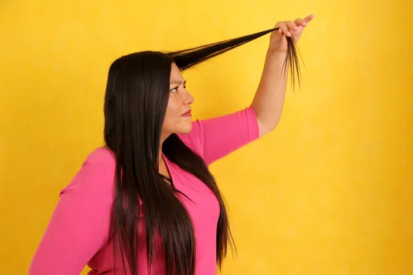 一头很长的直发的拉丁成年妇女很痛苦 很伤心 因为她的头发乱糟糟的 头发的两端都是分叉 — 图库照片