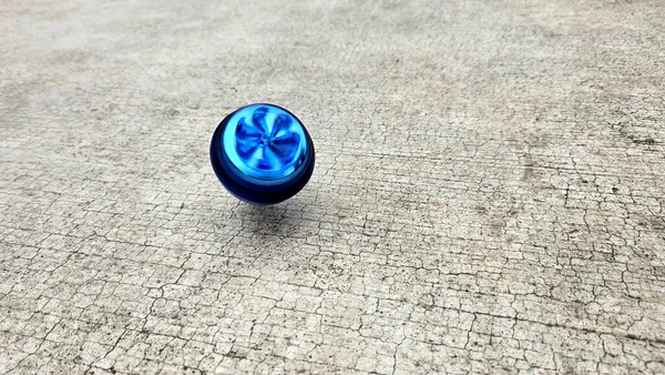 Blue spinning top, toy for children and adults, a type of spinning top that can rotate on one end, its gravitational center with a gyroscopic effect