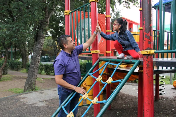 stock image Divorced single dad and 4-year-old daughter Latino brunettes play on outdoor park playground spend quality time together tech-free