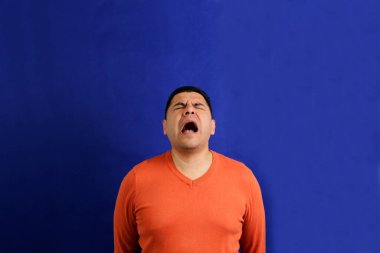 40-year-old latino man screams desperate, frustrated, anguished and distressed clipart