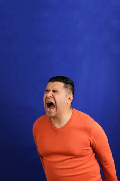 40-year-old latino man screams desperate, frustrated, anguished and distressed