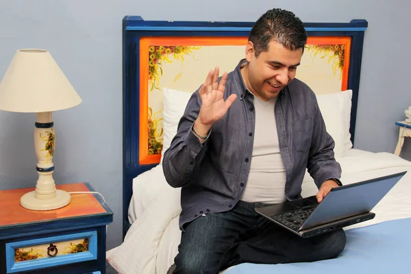 Homem Latino Anos Cabelos Escuros Usa Seu Laptop Sentado Cama — Fotografia de Stock