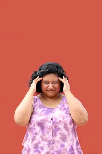 Young woman 20 years old latin brunette fat woman suffers from headache due to illness
