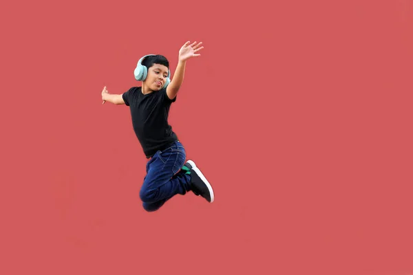 Year Old Dark Skinned Latino Boy Jumps Happiness While Listening — Stock Photo, Image