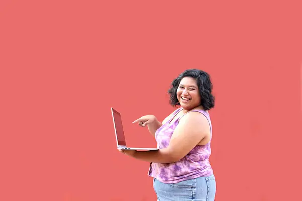 stock image Young 20 year old overweight brunette Latina woman uses her laptop to study, do homework, date, shop online and chat with her friends