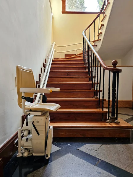 stock image A stairlift for going up and down stairs is an elevator system intended for elderly people or people with mobility problems, using a guide, it allows us to move through a mechanized chair