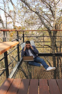 40 yaşındaki esmer tenli Latin adam bilgisayarını ve cep telefonunu dijital göçebe olarak kullanıyor. Ödemeler, alışverişler ve tarihler yapıyor.