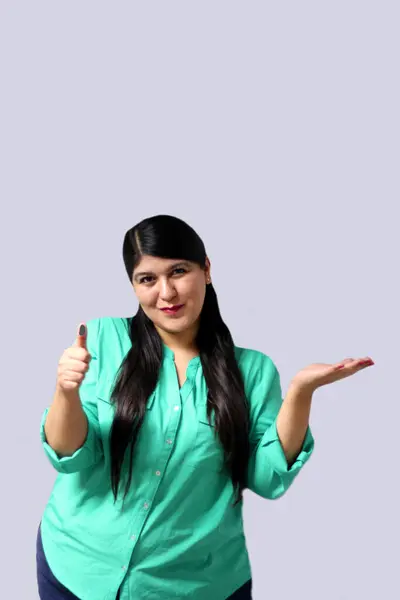 stock image 30-year-old Mexican adult woman shows her thumb indelible electoral ink as proof of vote to prevent fraud