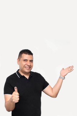 Dark-skinned Latino adult man shows his inked thumb after exercising his free and secret vote in Mexico clipart