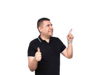 Dark-skinned Latino adult man shows his thumb inked with indelible electoral ink after marking his free and secret vote in the box clipart