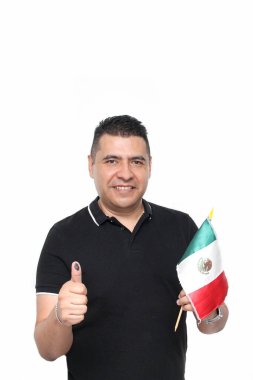 Dark-skinned Latino adult man shows his thumb inked with indelible electoral ink after marking his free and secret vote in the box clipart