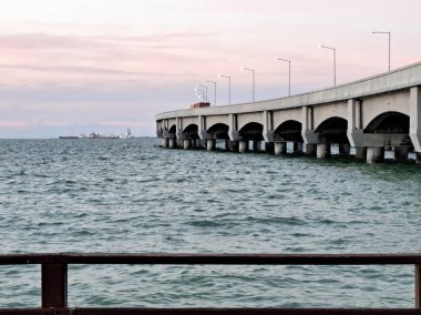 Progreso is a Mexican port city on the Yucatan Peninsula with its iconic arched pier and famous boardwalk clipart
