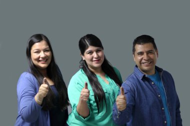 Two Latino women and a man show their thumb inked with indelible electoral ink after voting in the election clipart