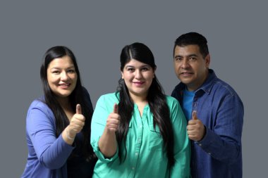 Two Latino women and a man show their thumb inked with indelible electoral ink after voting in the election clipart
