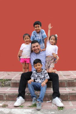 Divorced single dad with his two sons and two brunette Latina daughters spend quality time together celebrate Father's Day