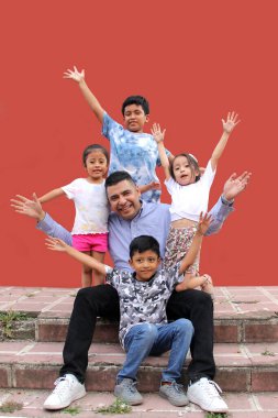 Divorced single dad with his two sons and two brunette Latina daughters spend quality time together celebrate Father's Day