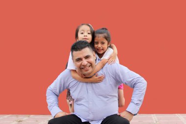 Divorced single dad plays with his two brunette Latina daughters show their love and celebrate Father's Day