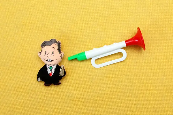 stock image Plush toy in the shape of the President of Mexico Andres Manuel Lopez Obrador AMLO taking the Mexican flag