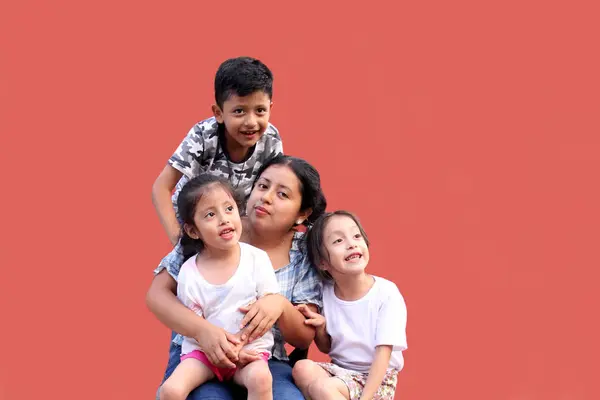 stock image Young Latina mom with 2 daughters and a son show their love with kisses and hugs to celebrate Mother's Day