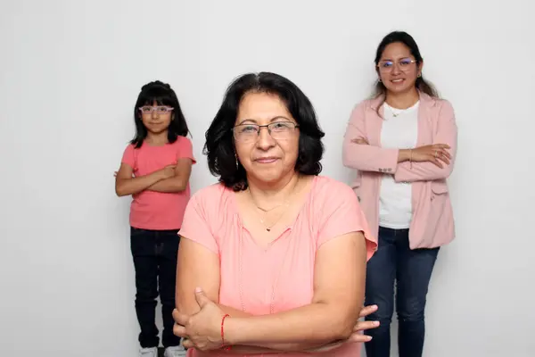 stock image Brunette Latina grandmother is pampered by her daughter and granddaughter, they take care of each other as a support network and celebrate Grandparents' Day