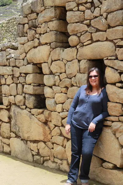 30 yaşındaki Latin bir kadın Cusco, Peru 'daki Machu Picchu arkeolojik alanını keşfediyor, selfie çekiyor ve turist olarak tatilinin tadını çıkarıyor.