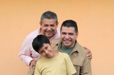 Koyu tenli Latin bir büyükbaba, baba ve oğulun üç nesli Babalar Günü 'nü kutlamak için sevgilerini gösterip birlikte vakit geçirdiler.