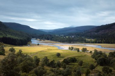 Autumn view of the river valley surrounded by mountains. Cairngorms, Highlands, Scotland.