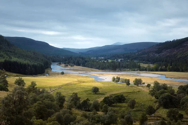 stock image Autumn view of the river valley surrounded by mountains. Cairngorms, Highlands, Scotland.