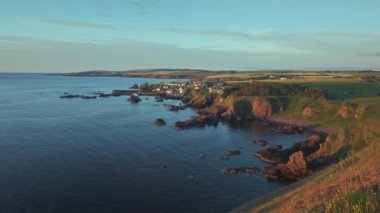 The south east coast of Scotland lit up by the morning sunshine. Video with the forward camera motion. Village of St. Abbs, Starney Bay - Nature Reserve, Berwickshire, Scotland, UK 